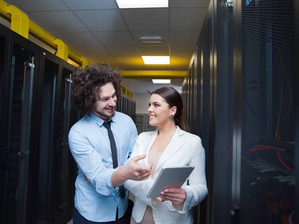 Engineer showing working data center server room to female chief — Stock Photo, Image