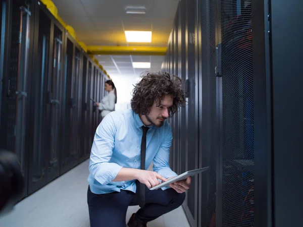 Young technicians working together on servers — Stock Photo, Image