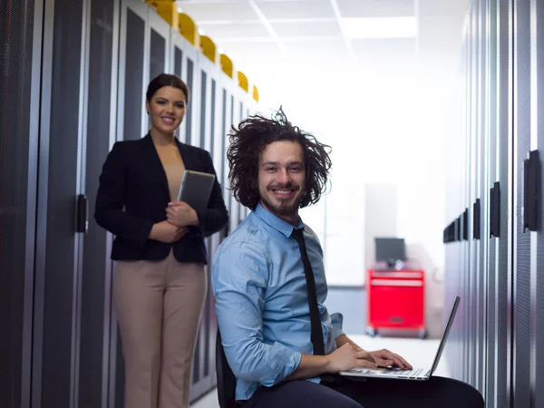 Equipo de jóvenes técnicos trabajando juntos en servidores — Foto de Stock