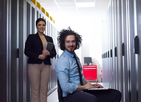 Team of young technicians working together on servers — Stock Photo, Image