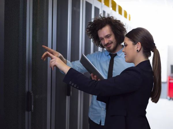 Engineer showing working data center server room to female chief — Stock Photo, Image