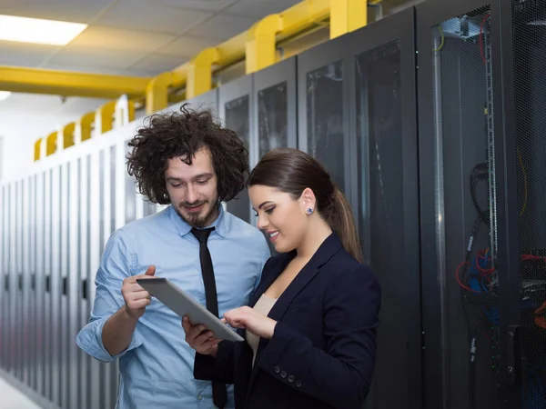 Engineer showing working data center server room to female chief — Stock Photo, Image