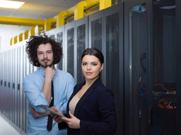 Engineer showing working data center server room to female chief — Stock Photo, Image