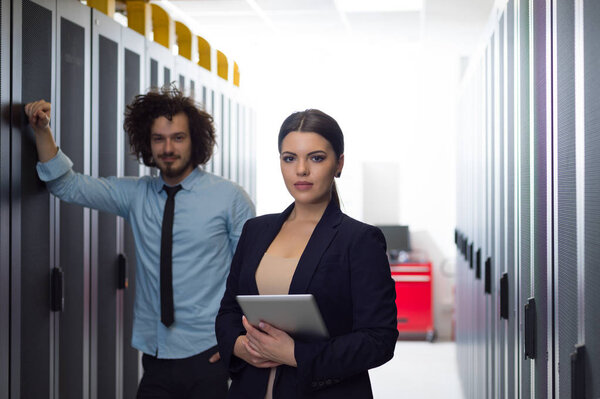 engineer showing working data center server room to female chief