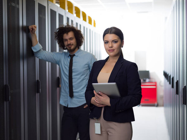 engineer showing working data center server room to female chief