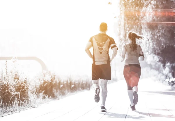 urban sports, healthy young couple jogging  in the city at sunny morning