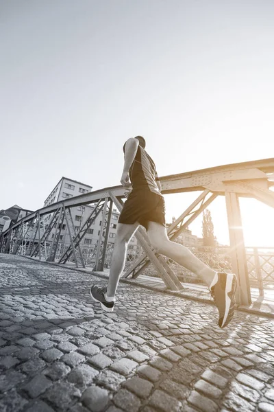 Sportieve Jongeman Joggen Brug Zonnige Ochtend Stad — Stockfoto