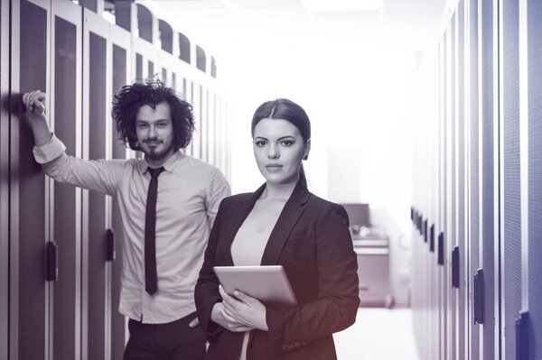 engineer showing working data center server room to female chief