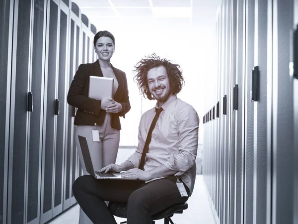 Engineer showing working data center server room to female chief — Stock Photo, Image