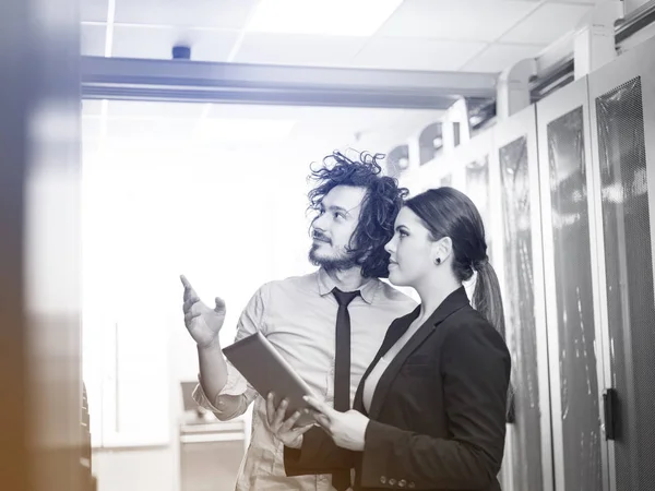 Engineer showing working data center server room to female chief — Stock Photo, Image