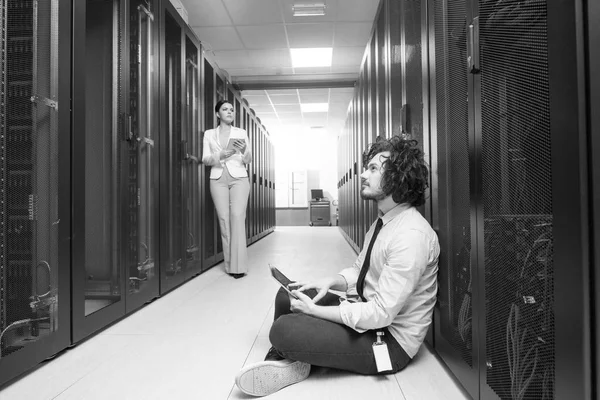 Engineer showing working data center server room to female chief — Stock Photo, Image