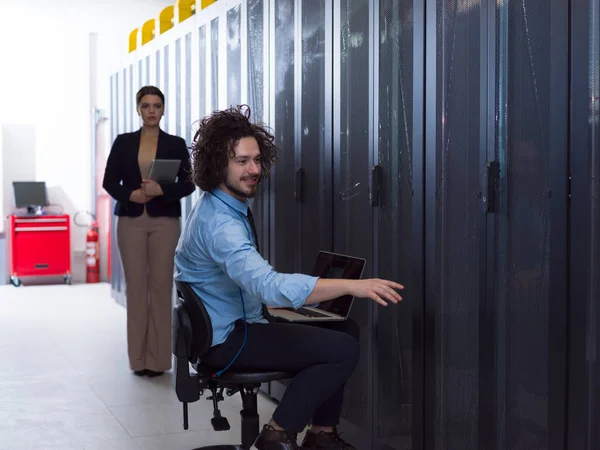 Team of young technicians working together on servers — Stock Photo, Image