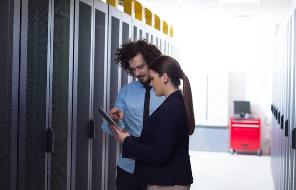 Engineer showing working data center server room to female chief — Stock Photo, Image