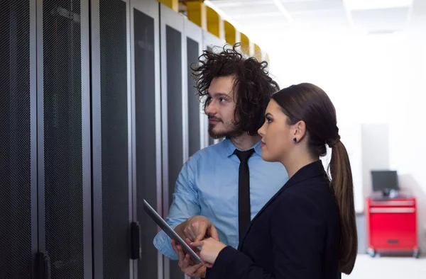 Engineer showing working data center server room to female chief — Stock Photo, Image