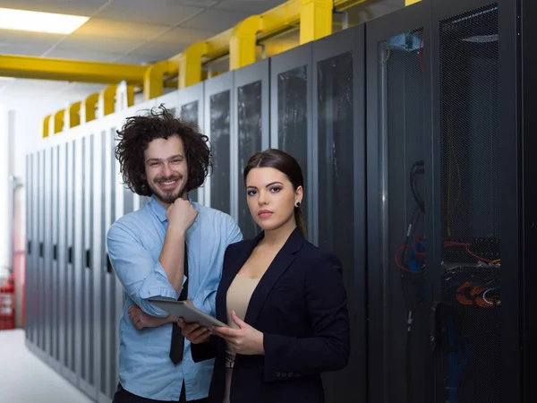 Engineer showing working data center server room to female chief — Stock Photo, Image