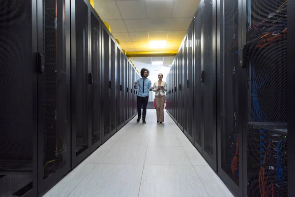 Engineer showing working data center server room to female chief — Stock Photo, Image