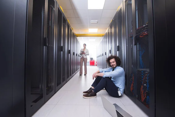 Team of young technicians working together on servers — Stock Photo, Image