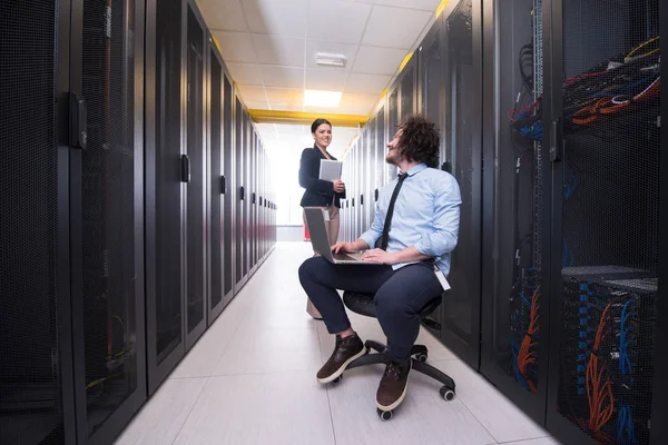 Team of young technicians working together on servers — Stock Photo, Image