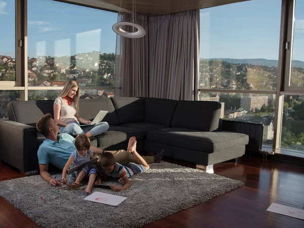 Happy Young Family Playing Together Home Floor Using Laptop Computer — стоковое фото