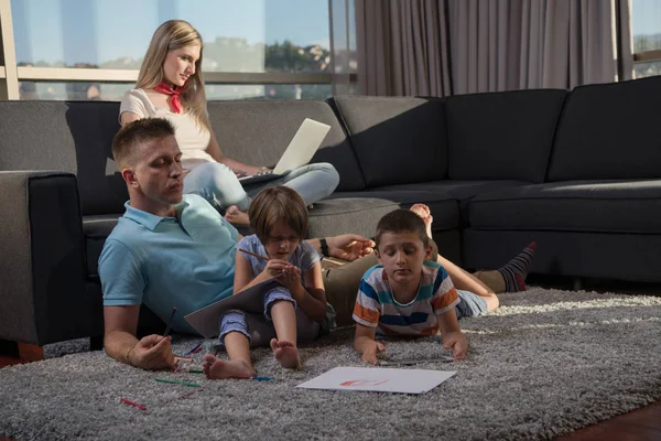 Happy Young Family Playing Together Home Floor Using Laptop Computer — стоковое фото