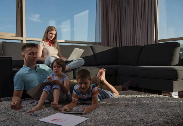 Happy Young Family Playing Together Home Floor Using Laptop Computer — стоковое фото