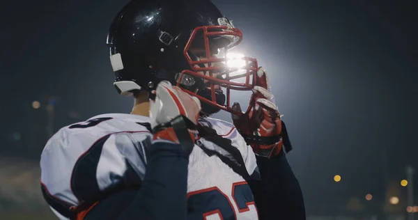 Jogador de futebol americano colocando no capacete em grande estádio com — Fotografia de Stock