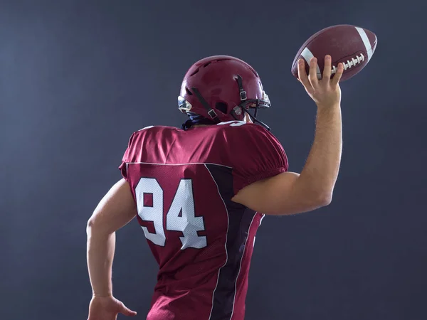 american football player throwing ball