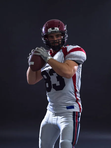 american football player throwing ball