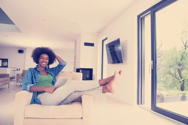 Mulher afro-americana em casa com tablet digital — Fotografia de Stock