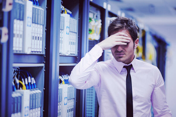 young handsome business man  engeneer in datacenter server room