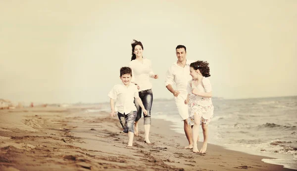 Happy young family have fun on beach — Stock Photo, Image