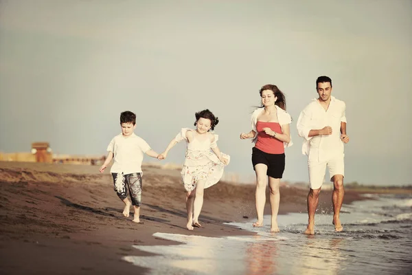 Happy young family have fun on beach — Stock Photo, Image