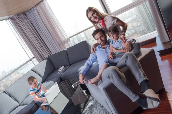 Happy young couple spending time with kids — Stock Photo, Image