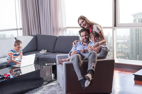 Happy young couple spending time with kids — Stock Photo, Image