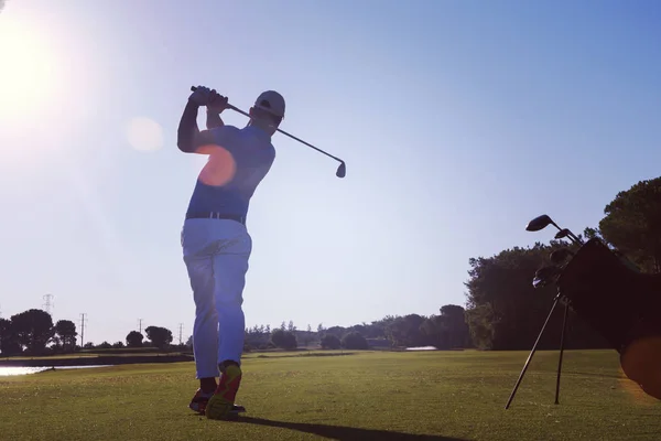 Golf player hitting long shot — стоковое фото