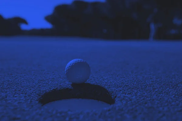 Golf ball in the hole — Stock Photo, Image