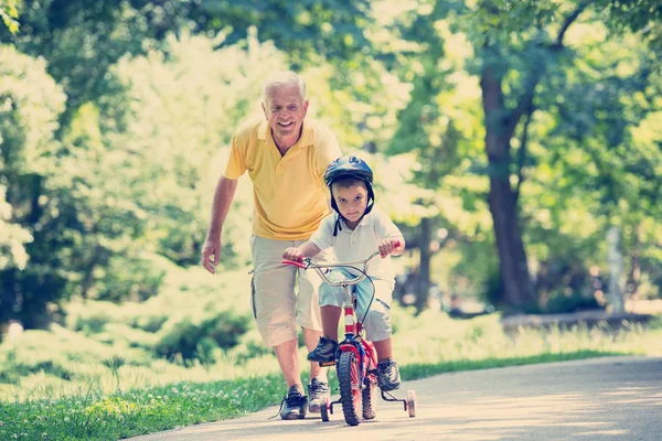 stock image happy grandfather and child have fun in park on beautiful sunny day