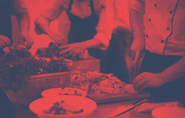 Team cooks and chefs preparing meals — Stock Photo, Image