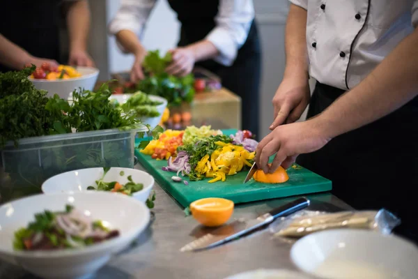 Equipo de cocineros y chefs preparando las comidas —  Fotos de Stock