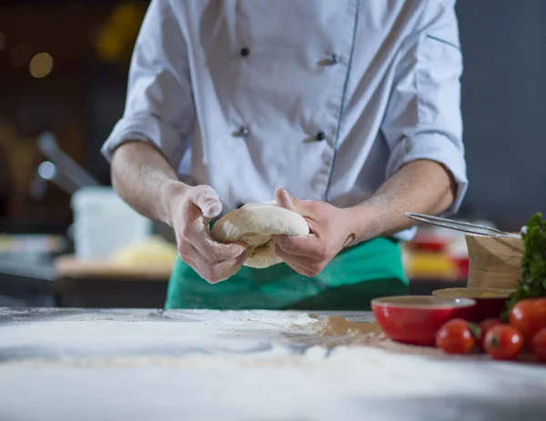 chef hands preparing dough for pizza