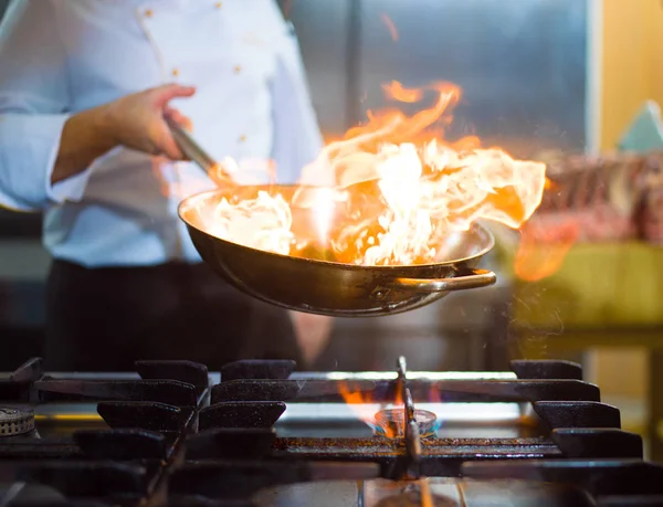 Chef fazendo flambe em alimentos — Fotografia de Stock