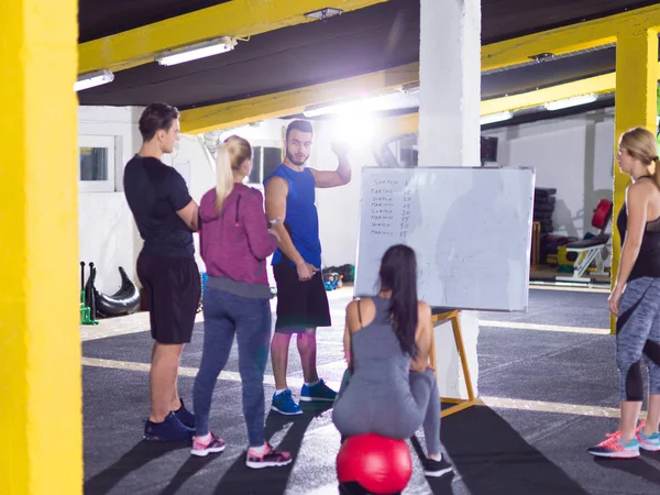 Athletes getting instructions from trainer — Stock Photo, Image