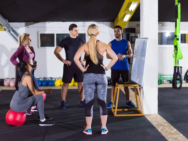 Athletes getting instructions from trainer — Stock Photo, Image