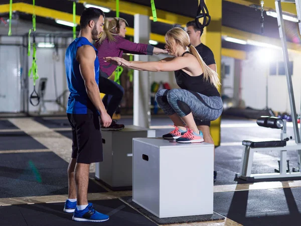 Athletes working out  jumping on fit box — Stock Photo, Image