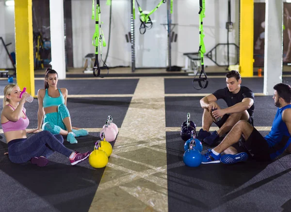 Grupo Jovens Atletas Sentados Chão Relaxantes Após Exercício Ginásio Crossfitness — Fotografia de Stock