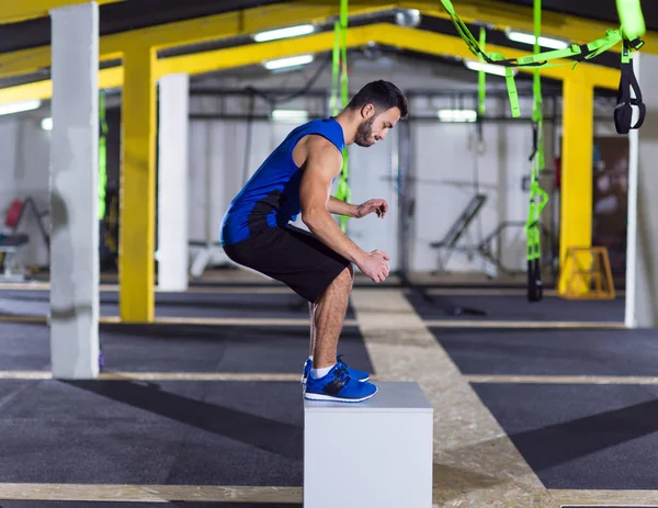 Man working out jumping on fit box — Stock Photo, Image