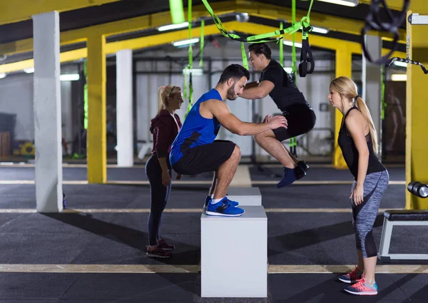 Athletes working out  jumping on fit box — Stock Photo, Image