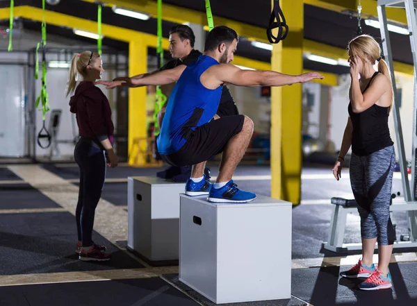 Athletes working out  jumping on fit box — Stock Photo, Image