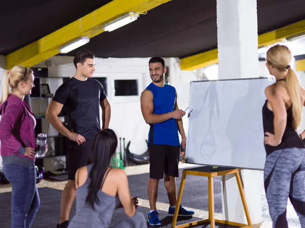 Athletes getting instructions from trainer — Stock Photo, Image