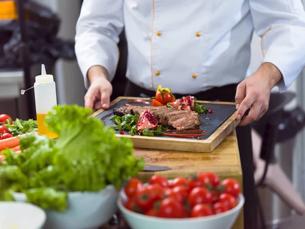 Closeup of Chef hands serving beef steak — Stock Photo, Image